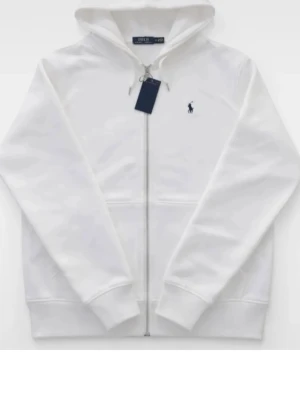 Vit Polo Ralph Lauren - Snygg vit hoodie från Polo Ralph Lauren med dragkedja framtill och klassisk blå logga broderad på bröstet. Hoodien har huva med dragsko, ribbade muddar och är tillverkad i mjukt bomullsmaterial. Perfekt för en clean och stilren look.