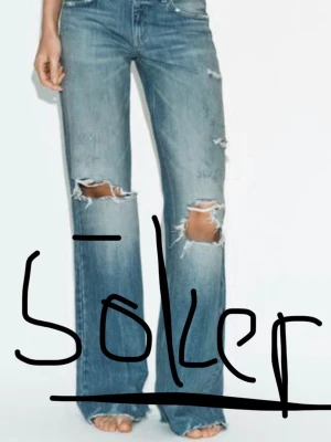 Blå slitna bootcut jeans - SÖKER!!! Kan betala mer än vad dom kostar på hemsidan. Söker storlek 34!!!