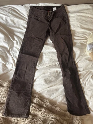 Bruna bootcut jeans med lågmidja  - Säljer ett par bruna lågmidjadebyxor med bootcut passform. Är i stinker 34.