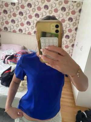 Kornblå topp med volangärmar - Snygg kornblå topp från Vero Moda med korta ärmar och volangdetaljer på axlarna. Enkel rund halsringning och rak passform. Perfekt för dig som vill ha en färgklick i garderoben.