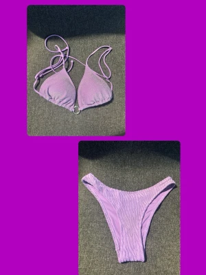 Lila bikini med snörning - Snygg lila bikini med trekantsöverdel och snörning i ryggen. Underdelen har hög midja och enkel design. Perfekt för stranden eller poolen. Materialet känns mjukt och stretchigt för en bekväm passform.