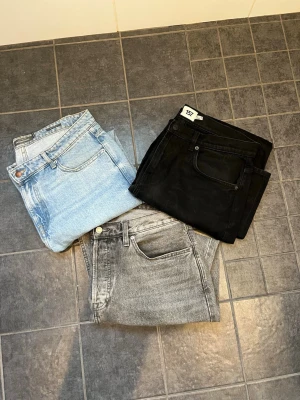 3-pack jeans från Dressmann & 157 - Säljer tre par jeans från Dressmann i olika färger: ett par ljusblå, ett par svarta och ett par grå. Klassisk femficksmodell med raka ben och normal midja. Perfekta basjeans för alla tillfällen. Materialet är mjukt denimtyg i bomull.