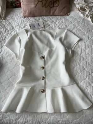 Tajt peplum topp med guldknappar - Helt oanvänd zara topp med etiketten kvar. Tajt peplumtopp med guldknappar, perfekt gå-ut topp!! Storlek L