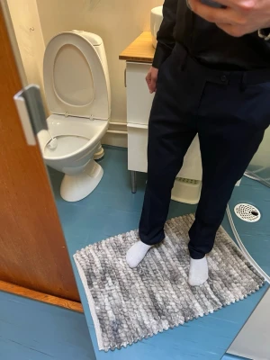 Mörkblå kostymbyxor med slim fit - Snygga mörkblå kostymbyxor med slim fit och klassisk design. Byxorna har pressveck, hällor för bälte och stängs med knapp och dragkedja. Perfekta för en stilren look och passar till skjorta eller t-shirt., storlek 29/32