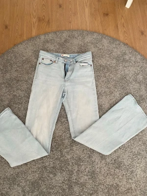 Levi's 726 Flare ljusblå jeans - Säljer ett par snygga ljusblå Levi's 726 Flare jeans med klassisk femficksdesign och utsvängda ben. Jeansen har hög midja och är tillverkade i denim med en cool vintagekänsla. Perfekta för dig som gillar retrostil och vill sticka ut.