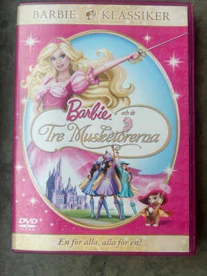 Barbie & de tre musketörerna dvd - Barbie och de Tre Musketörerna på DVD. Filmen har svenskt tal och text. Speltid: 1 timme 21 minuter. Produktionsår: 2009.  Finns på språk: Svenska, Engelska, Finska   OBS!! skivorna är begagnade så det kan förekomma repor/hairlines på skivorna, men då jag kollar igenom alla filmer jag säljer garanterar jag att alla funkar felfritt om inget annat står! :)