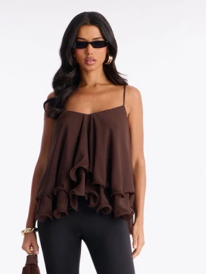 Brun volang topp med smala band - Säljer en brun linnetopp med tunna axelband och flera lager volanger. Aldrig använd!! Kommer i orginalförpackning 