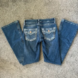 Blåa Bootcut Jeans med vit stitchning - Fina låg/medel midjade, bootcut/flare jeans från gina, använt ett par gånger🩷defekt på sista bild