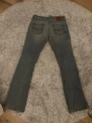 Blå bootcut jeans - Supersnygga lågmidjade vintage jeans med detaljer på bakfickorna 💕