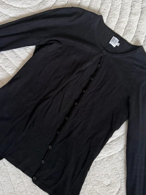 Svart kofta  - Super söt svart kofta från  med rund halsringning och knäppning framtill. Långärmad modell i tunt, mjukt material