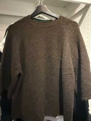 Brun stickad tröja Gina Tricot - Mysig brun stickad tröja från Gina Tricot med rund halsringning och långa ärmar. Tröjan har en enkel, rak passform och ribbade muddar vid halsen. Perfekt för lager på lager och höstiga dagar.