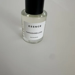 ESSNCE Carashmellow  - Helt by parfymflaska från ESSNCE med doften Carashmellow. Som man ser på bilden är det knappt 3 sprutor använda. Nu är parfymen mörkare i färg sen jag tog bilden alltså den här en mörk gul färg nu! Flaskan är  genomskinlig med svart lock och vit etikett med svart text. Modern och stilren design, perfekt för dig som gillar unika dofter. 