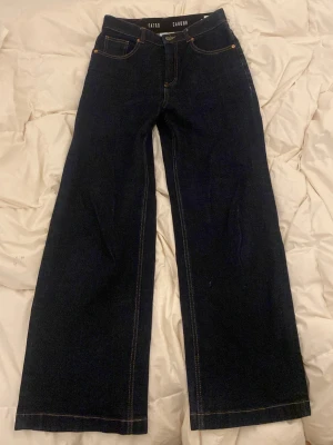 Mörkblå wide leg jeans  - Jean Madgoodgan, it gives wide straight fit. There is a bending around the waist, and is high waisted