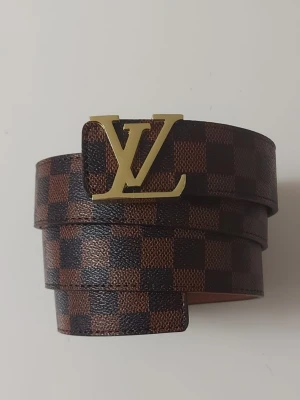 L bälte brun - Helt nytt brunt bälte. Aldrig använt, i perfekt skick. Längd: 105 cm. Klassisk design, se bilder för detaljer.