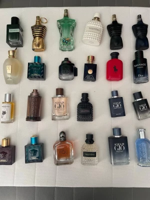 Säljer/byter parfym kom med förslag! - Samling med lyxiga herrparfymer från märken som Jean Paul Gaultier, Valentino, Dior, Giorgio Armani, Versace och Ralph Lauren. Flaskorna har olika former och färger, från klassiskt svart och blått till grönt, rött och vitt. Perfekt för dig som vill ha variation och stil i din doftgarderob.
