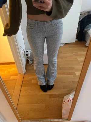 Ljusgrå leopardmönstrade jeans - Säljer ett par ljusgrå jeans med leopardmönster. Materialet är denim och perfekta för dig som vill sticka ut med ett coolt mönster.❣️❣️