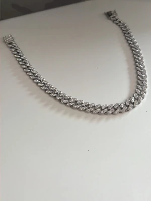 Halsband - Snyggt armband i cuban länkstil med silverfärg och glittrande stenar på varje länk. Armbandet har ett robust lås och ger en riktigt lyxig känsla. Perfekt för dig som vill sticka ut med accessoarer som syns.