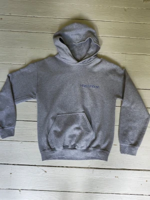 Harry Styles hoodie - Grå Harry Styles, Harry's House hoodie. Officiell merch. En liten del av sömmen på fickan har lossnat (inget som påverkar funktionen, och lättfixat om man vill laga) men förövrigt jättebra skick.