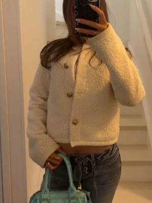 Krämvit teddy cardigan med knappar - säljer min supersöts teddyjacka med guld detaljer, köpt ifrån gina för typ ett år sedan och kommer inte till användning men perfekt till våren 