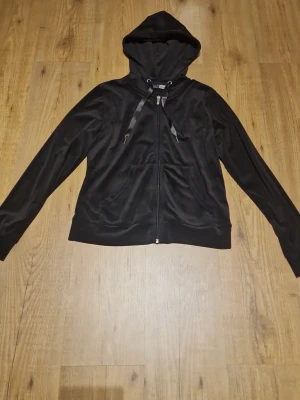 Svart zip hoodie med huva - Snygg svart hoodie från Gina Tricot i mjukt material. Hoodien har dragkedja framtill, huva med snören och ribbade muddar vid ärmslut och nederkant. Perfekt för en avslappnad och trendig look.