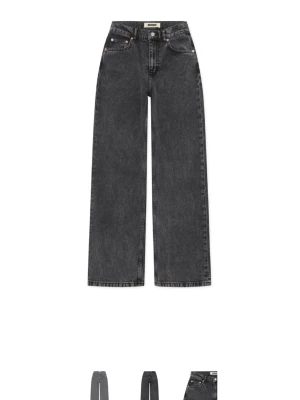 Svarta wide leg jeans från Woodbird - Säljer ett par svarta wide leg jeans från Woodbird med hög midja och raka ben. Jeansen har klassiska femficksdetaljer och är gjorda i kraftig denim. Perfekt för dig som gillar en avslappnad och trendig look.