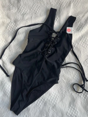 Ny Baddräkt 🖤 - Snygg baddräkt med snörning från Bik Bok i storlek XS. Ny med prislappar kvar! Nypris 349kr 🖤