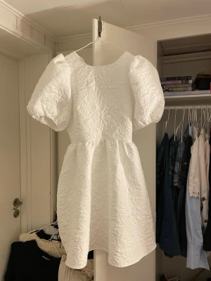 Super fin student klänning - Supersöt vit kort klänning med puffiga kortärmar och strukturmönstrat tyg perfekt till studenten. Endast provad😊