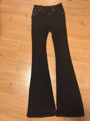Svarta utsvängda jeans - Säljer ett par svarta jeans med utsvängda ben och klassisk femficksmodell. Jeansen har hög midja och är perfekta för dig som gillar retrostil. Dessa jeans skulle jag säga sitter som en 32a i storlek, stilrena och super bekväma att ha längre tid på sig. Det är i mycket bra skick och ej slitna i tyget eller utsträckta. Dessa fina jeans är från lager157 och original priset är 400kr☺️