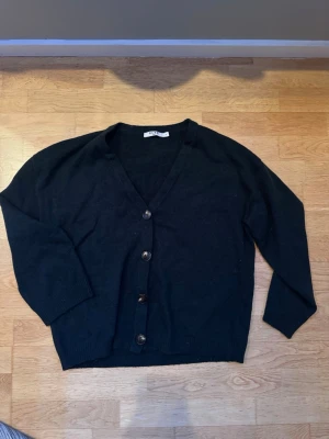 Kofta från NA-KD - Fin mörkgrön kofta från NA-KD med v-ringning och knappar. Den är oanvänd och säljes då den inte kommer till användning!