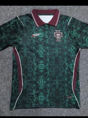Portugal grön matchtröja Nike - Snygg Portugal matchtröja från Nike i mörkgrönt med mönster, vinröda detaljer och vit piping. Tröjan har korta ärmar, krage och Portugal-emblem på bröstet. Perfekt för fotboll eller träning. Du kan bestämma vilken storlek du vill ha!!! Det kan ta upp till 15-20 dagar för tröjorna att komma!!! 