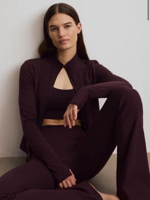 Mörklila/vinröd träningsset med zip-jacka - Säljer ett mörklila träningsset som består av en zip-jacka och utsvängda byxor. Setet är tillverkat i ett stretchigt och mjukt material som sitter tight och följer kroppen. Perfekt för gymmet eller yoga. 