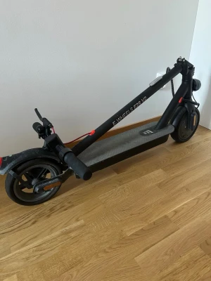 Svart elscooter E-WHEELS E2S V2 35KM/H - Hopfällbar svart elscooter E-WHEELS E2S V2 35 KM/H med robust ram, bred ståplatta och handtag med greppvänligt gummi. Utrustad med fram- och bakljus samt reflexer. Perfekt för smidig transport i stan. OBS framdäcket måste pumpas med luft!! HÄMTAS HELST I ESKILSTUNA!