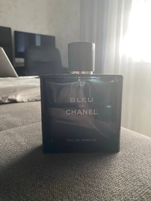 Bleu de Chanel Eau de Parfum 100ml - Bleu de Chanel Eau de Parfum, flaska på 100 ml.  Fortfarande en bra mängd kvar (se bild) Klassisk mörkblå glasflaska med spraykork.  Detta är en otroligt fräsch och maskulin doft med en perfekt balans av krispig citrus och djupa, träiga noter, en parfym som passar till absolut allt.