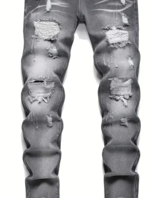 Grå slitna jeans med hål - Snygga grå jeans med slitningar och stora hål på både lår och knän. Jeansen har en tight passform och trendigt tvättad look som ger en cool streetstyle-vibe. Perfekta för dig som gillar en edgy stil.