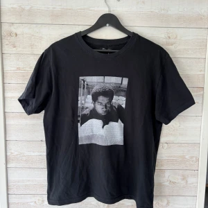 T-shirt från OneWear - Svart t-shirt från OneWear med ett svartvitt tryck på bröstet. Klassisk rund halsringning och normal passform. Perfekt för en avslappnad och cool stil.