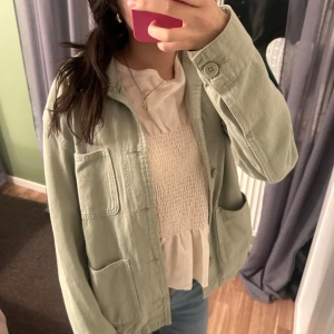 Ljusgrön jacka från Zara - Säljer en ljusgrön vårjacka från Zara med tre stora fickor framtill och knäppning. storlek s