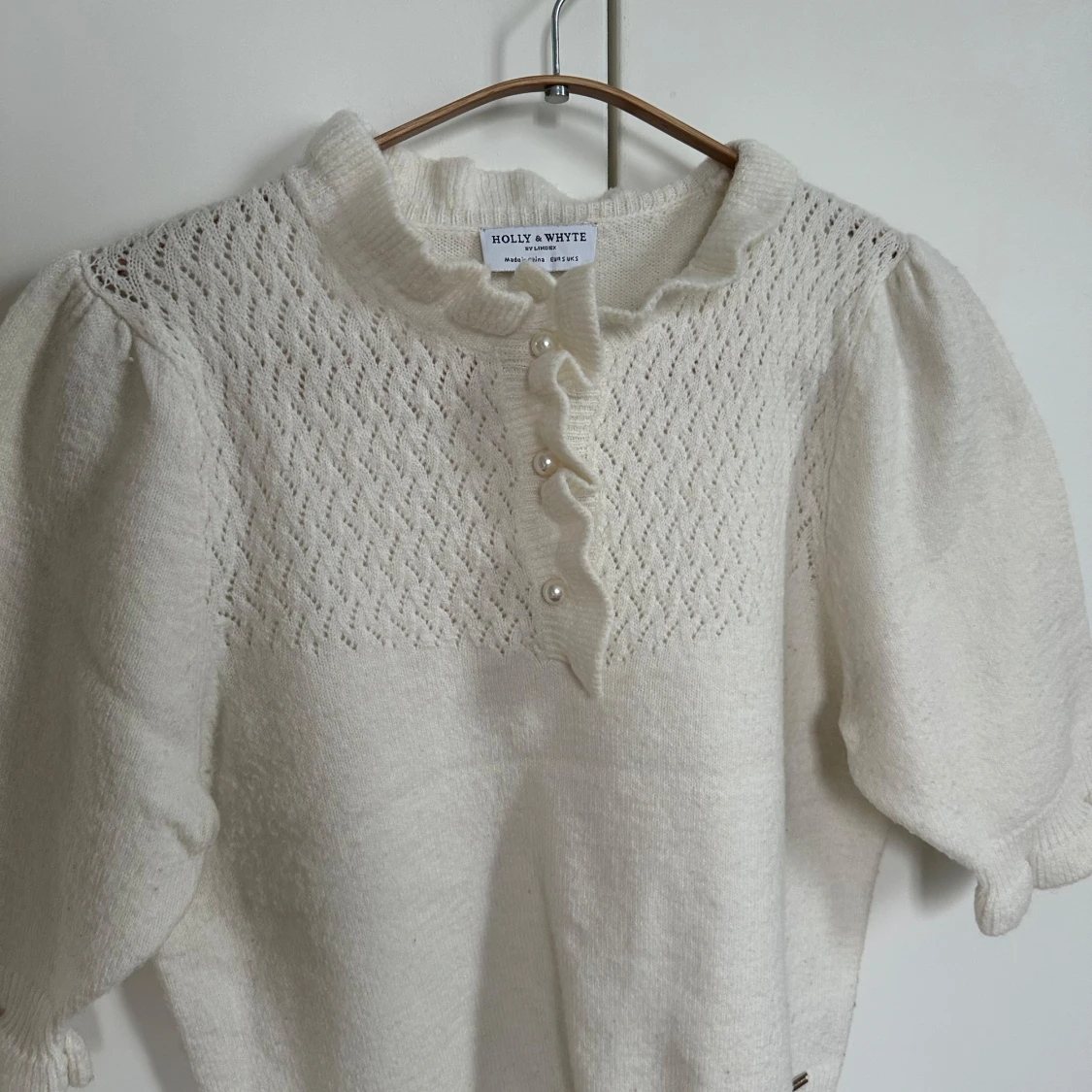 Vit stickad tröja med pärlknappar från Holly & Whyte