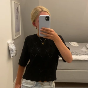 Svart stickad topp med mönster - Snygg svart stickad topp med diskret hålmönster och halvlånga ärmar. Perfekt till hösten🥰