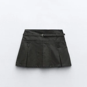 Svart minikjol med bälte - Svart kortkjol med snygga veck och ett smalt bälte i midjan. Köpt på zara.