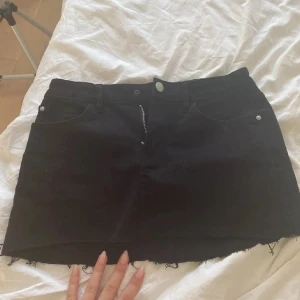 Svart jeanskjol med rå kant - Svart kort jeanskjol med rå, fransig kant 