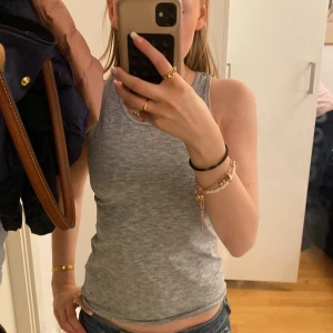 Grått träningslinne - Grått träningslinne från H&M. Lite öppen där bak och tight. Perfekt för dig som gillar att träna.