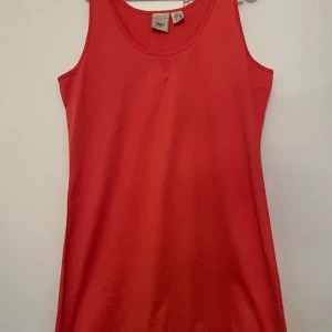 Linne  - Enkel och snyggt linne  från Ellos. Modellen är ärmlös med rund halsringning och rak passform, perfekt för varma dagar. Stilren design utan mönster eller detaljer, lätt att matcha med accessoarer. Linnet är mer mot det rosa hållet 