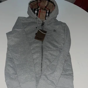Burberry Zip Grå - Säljer en riktig fin Burberry i en Grå färg med beige inne, Helt ny.