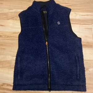 Blå fleeceväst från Morris - Säljer en snygg fleeceväst från Morris i storlek M! Den är i gott skick och har inga defekter. Nypris ligger på runt 2000kr. Hör av dig vid funderingar eller fler bilder!