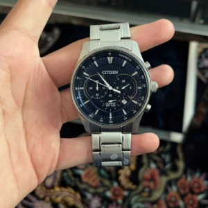 Citizen herrklocka med blå urtavla - Stilren Citizen herrklocka med blå urtavla och silverfärgat armband i rostfritt stål. Klockan har kronograf, datumvisning och tydliga indexmarkeringar. Robust design med flera knappar på sidan och klassiskt spänne. Perfekt accessoar för dig som gillar snygga detaljer.