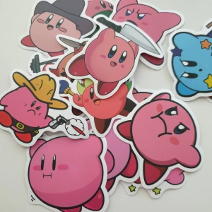 15st Kirby Stickers Collection - En samling färgglada klistermärken med Kirby i olika roliga och coola poser – perfekt för att dekorera dator, mobil eller anteckningsbok! Varje sticker är ca 5 cm bred och passar dig som älskar spel och vill visa din personlighet.