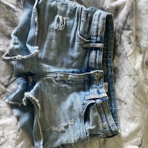 Ljusblåa jeansshorts med slitningar - Snygga ljusblå jeansshorts från Denim med slitningar framtill. Klassisk femficksmodell med knapp och dragkedja 🤍 jag säljer då dom är för tajta i låren. Skriv för fler bilder 💋