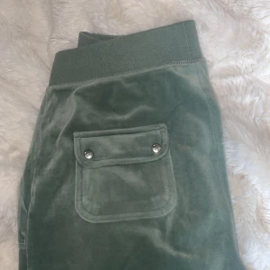 Gröna velourbyxor från Juicy Couture - Säljer mina ljusgröna Juicy Couture byxor, använda ca 3 gånger. Lite knottriga vid midjan men syns inte. Säljer pga kommer aldrig till användning.❤️