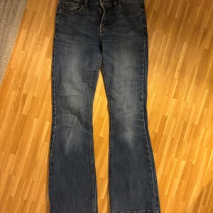 Blå bootcut jeans - Snygga blå bootcut jeans från Lindex med fransiga kanter. 