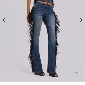 (Intressekoll) Jaded London Fringe Bootcut Jeans - Blå bootcut jeans med svarta fransar längs sidorna. Jeansen har låg midja och klassisk femficksdesign. Materialet är denim och fransarna ger en unik look. Originalpris 1600kr + frakt. Säljer då retur kostar 175kr.